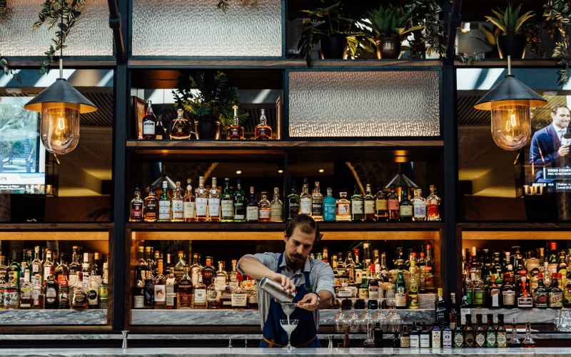 A bartender mixes a drink at Press Room in New Orleans