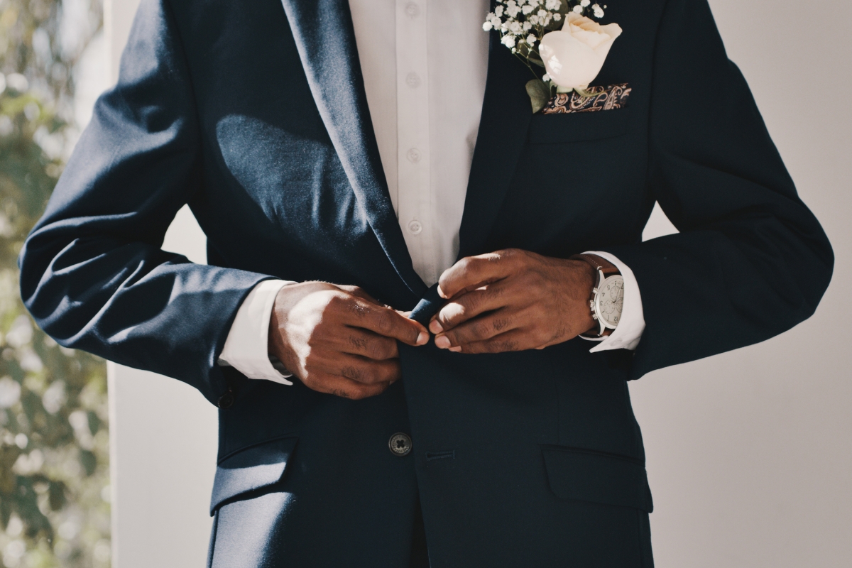 A groom adjusting his tux at The Eliza Jane in New Orleans