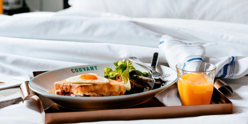 Tray of breakfast resting on a hotel bed