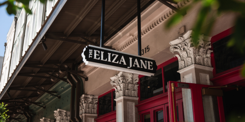 sign hanging from building that says The Eliza Jane