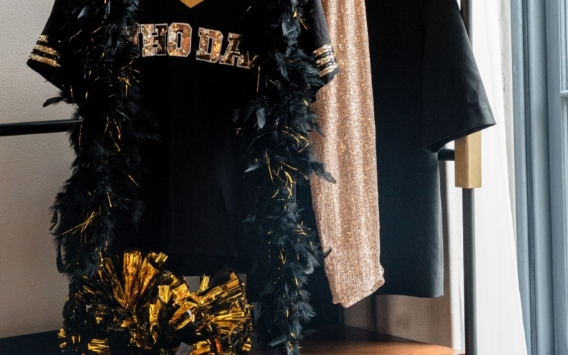 Black gold and yellow sports jersey and clothes with black and gold pom pops
