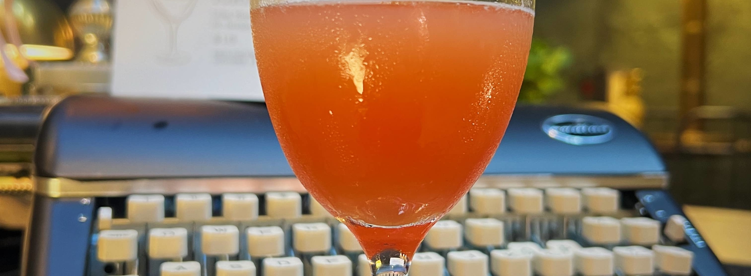 cocktail in front of a typewriter