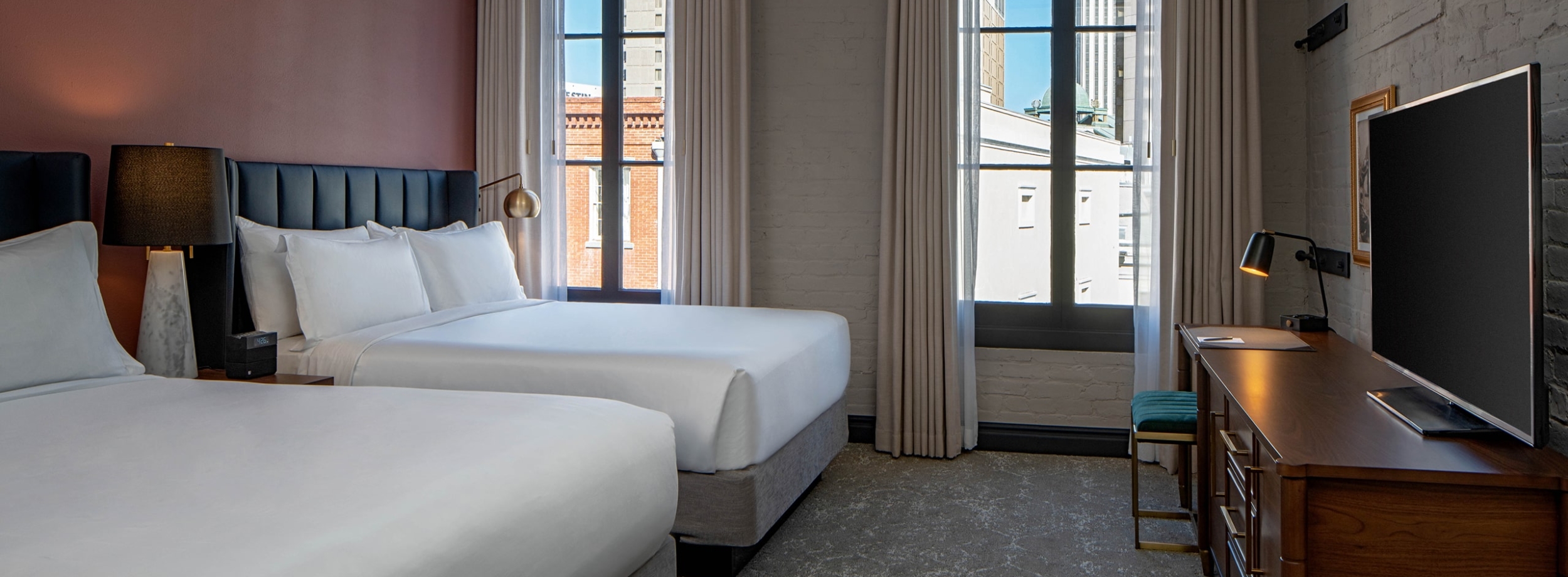 A two queen guest room at The Eliza Jane Hotel in New Orleans