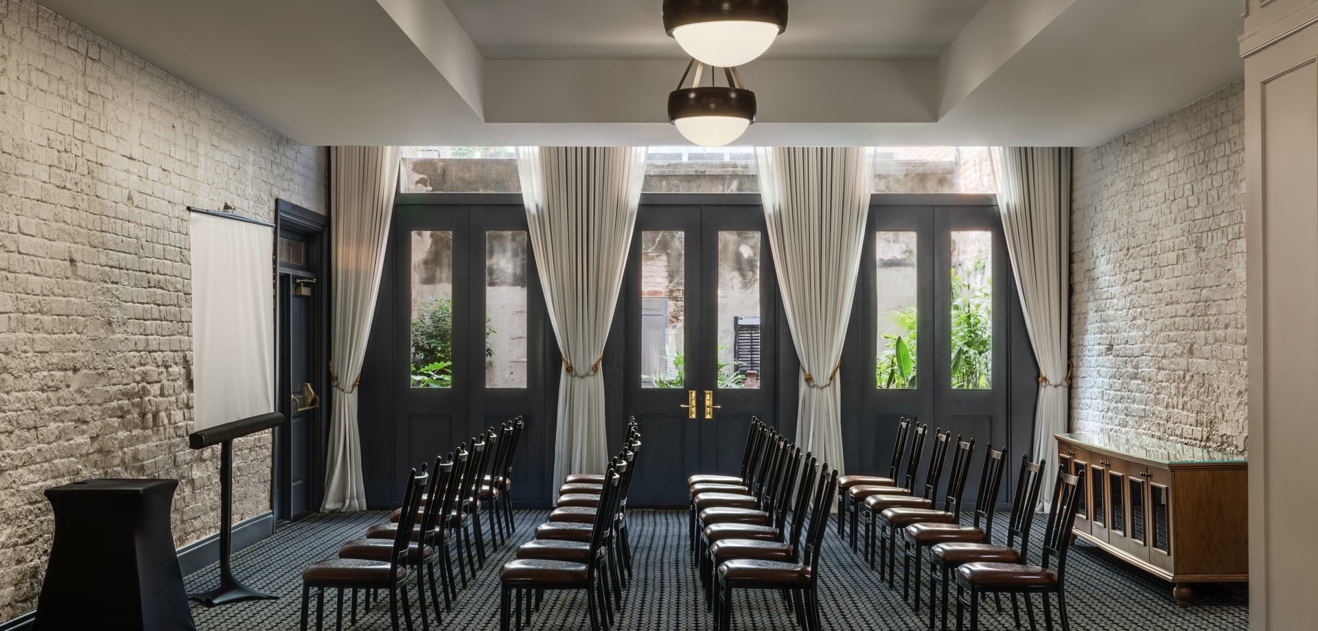 meeting room with rows of chairs lined up in front of a screen